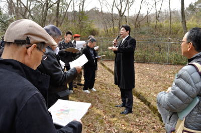 塩漬け土地ツアーに参加した人々＝2013年1月20日、奈良市鳥見町4丁目と二名7丁目の塩漬け山林の境界付近