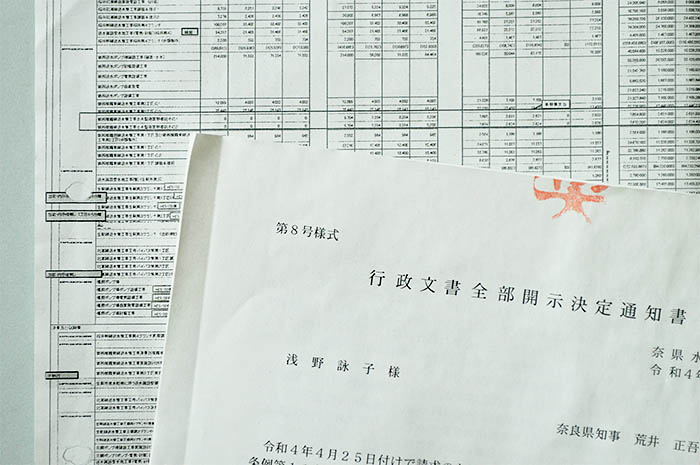 県の開示決定通知書と、文字がつぶれたり、かすれたりしている開示文書